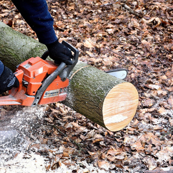 A Husqvarna chainsaw cutting through a log