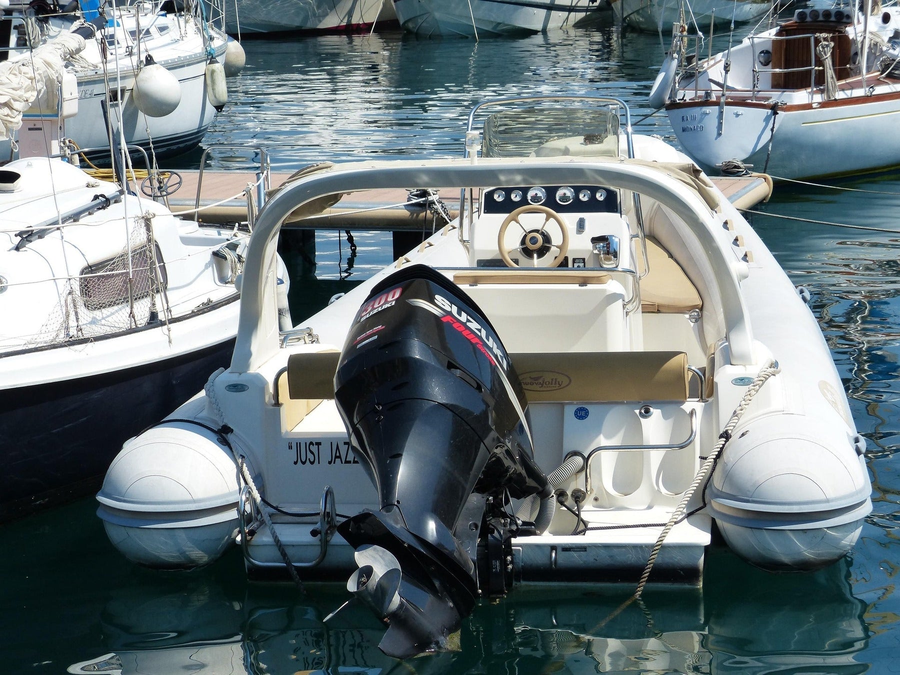 A small boat with a black Mercury outboard engine docked