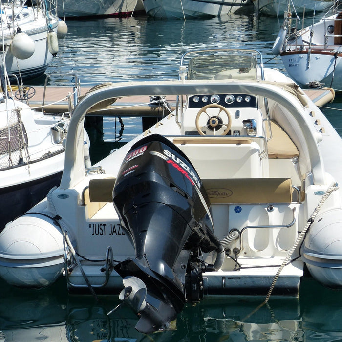 A small boat with a black Mercury outboard engine docked
