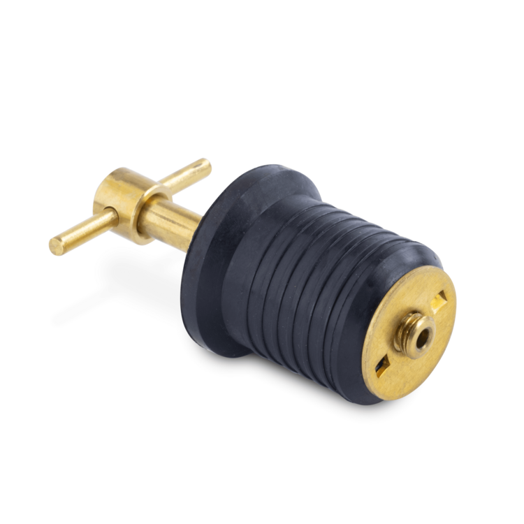 Black and brass colored drain plug on a white background