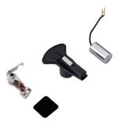 Tune up kit components including a black plastic main plate, a silver metal press foot, a black square patch, and a silver cylindrical component with a black wire and gold connector, all arranged on a plain white background.