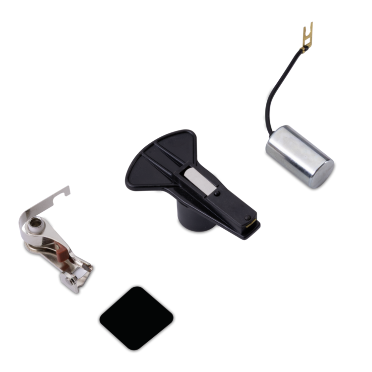 Tune up kit components including a black plastic main plate, a silver metal press foot, a black square patch, and a silver cylindrical component with a black wire and gold connector, all arranged on a plain white background.