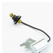 A small automotive electrical component with a black wire, a black and yellow connector, and a silver metal mounting base, photographed on a plain white background.
