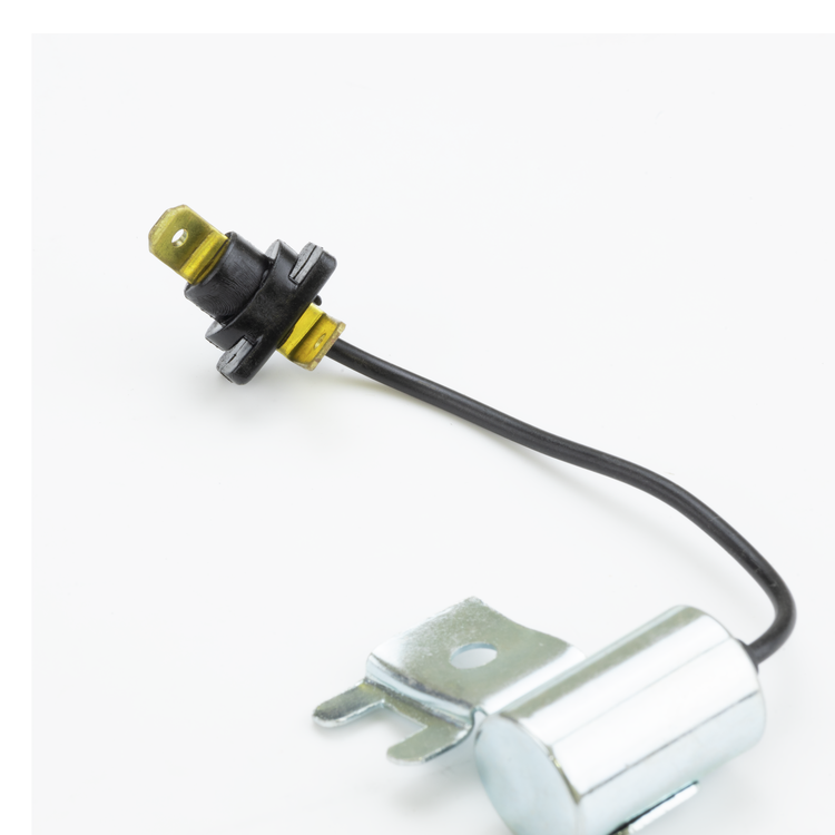 A small automotive electrical component with a black wire, a black and yellow connector, and a silver metal mounting base, photographed on a plain white background.