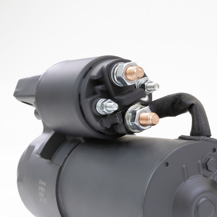 Close-up of a black Sierra starter motor on a white background