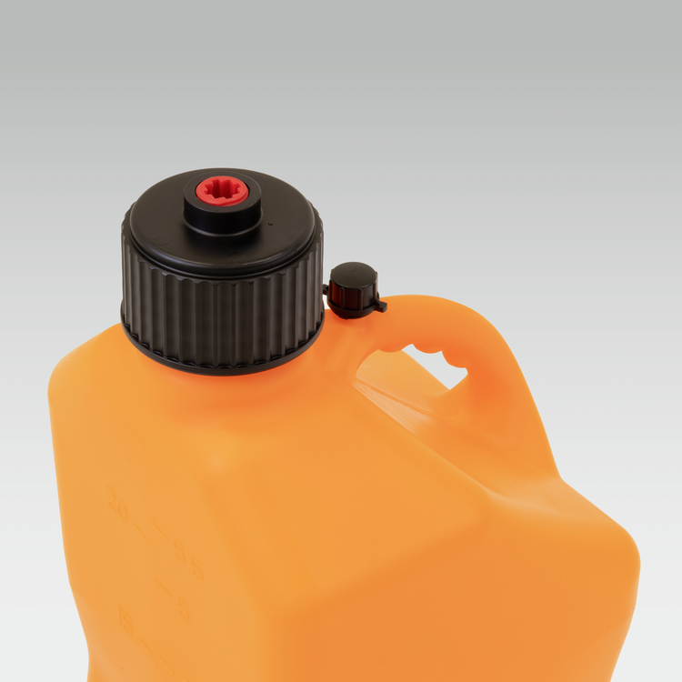 Orange plastic container with black cap on a gray background