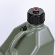 Green plastic container with black cap on a light gray background