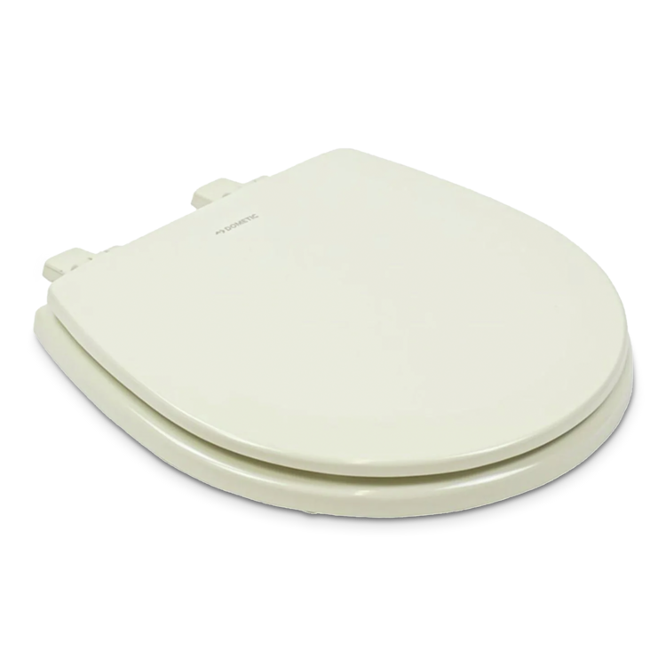 Closed beige Dometic toilet seat on a white background