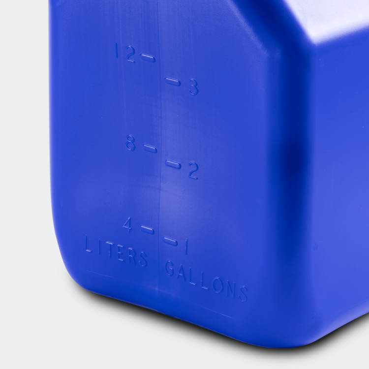 Close-up of a blue container with measurement markings on a white background