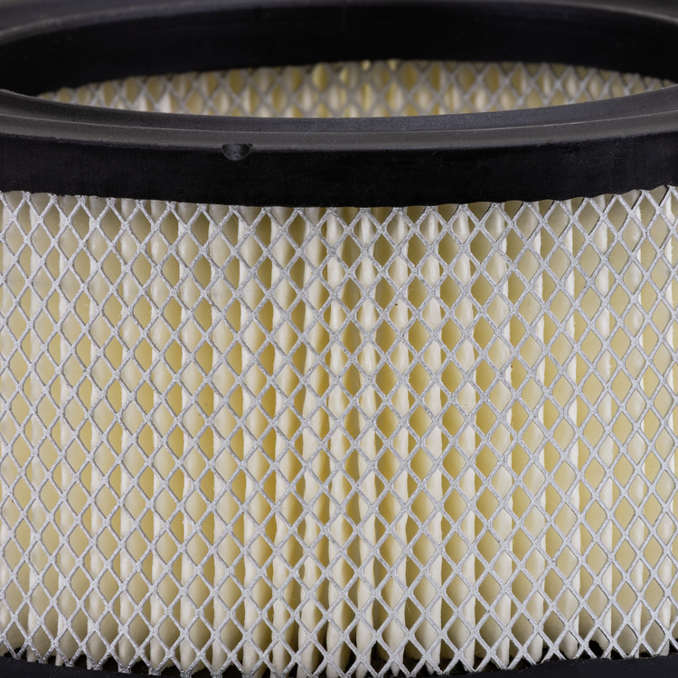 Close-up of a round air filter with a black rim on a white background