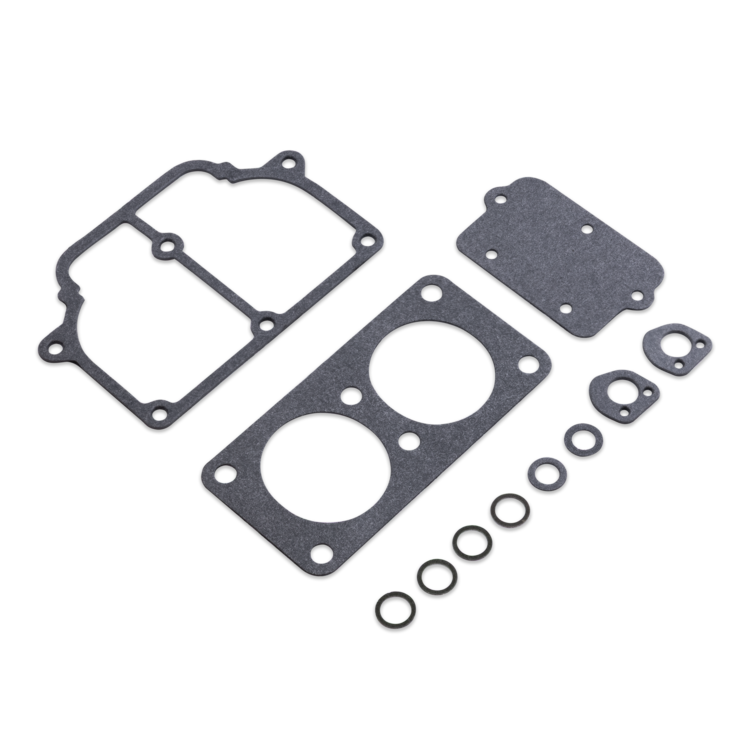 A set of dark gray engine gaskets and O-rings arranged on a plain white background.