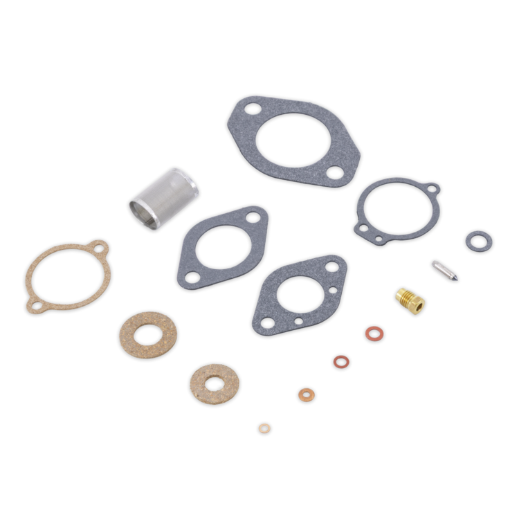 A set of mechanical gaskets and seals laid out on a white background, including multiple circular gaskets, O-rings, washers, a metal sleeve, and small brass and steel hardware pieces.