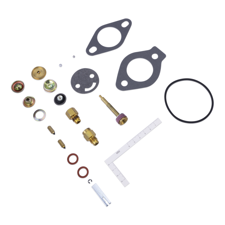 A flat lay of a small mechanical parts kit on a white background, including gaskets, O-rings, brass and silver metal fittings, washers, screws, and a white ruler.