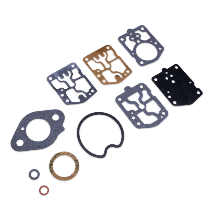 A set of engine gaskets and O-rings arranged on a plain white background. The set includes several flat rectangular and irregular gasket pieces in dark gray, black, and bronze/copper tones, along with multiple O-rings in black, bronze, and red.