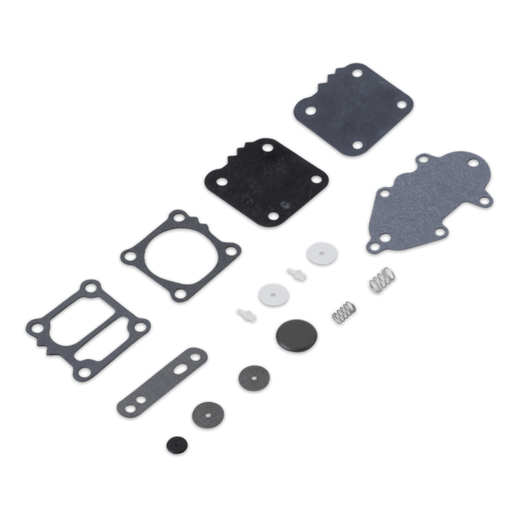 A set of flat gaskets, seals, washers, and small metal springs arranged in a diagonal layout on a plain white background.