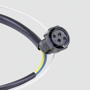 A close-up of a black multi-pin electrical connector attached to a black cable, with white, yellow, and blue wire strands visible, on a light gray background.