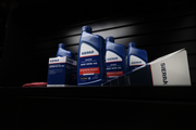 Sierra oil products including bottles and boxes on a dark background