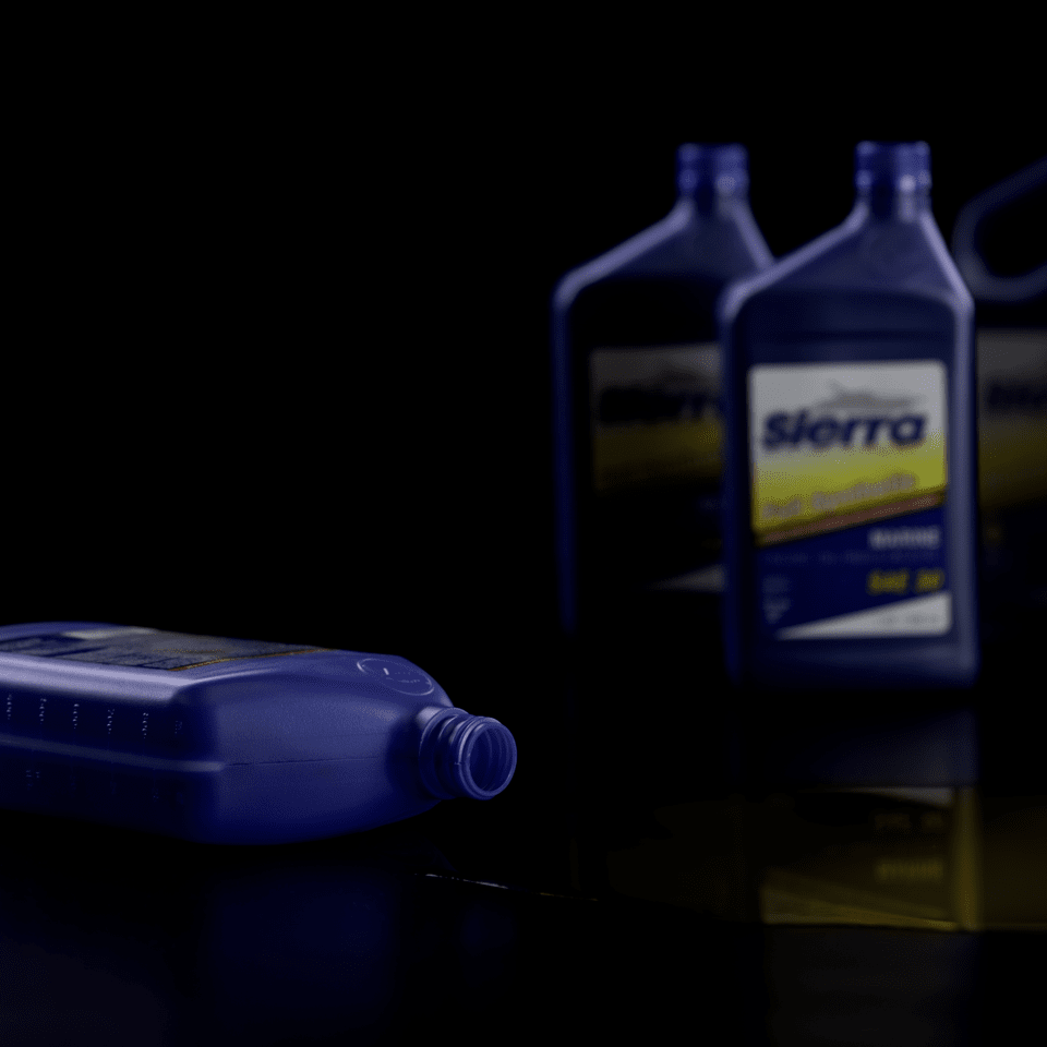 Empty Sierra boat oil bottles against a black background