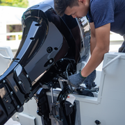 A man working on an outboard engine