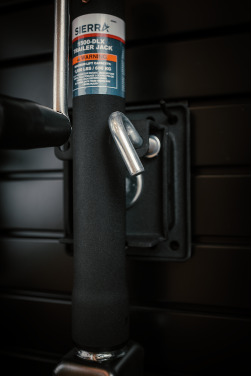 Black trailer jack handle with Sierra label on a dark background