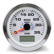 A round speedometer gauge with a chrome bezel, white face, black markings, blue MPH and km/h sub-dials, and an orange needle. A small digital display is visible at the bottom center.