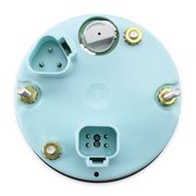 The underside of a circular speedometer housing, featuring a light blue plastic casing with various electrical connectors, terminal screws, and a central socket.