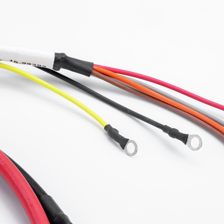 Close-up of multi-colored electrical wire leads with ring terminals, including red, yellow, black, orange, and gray wires, on a white background.