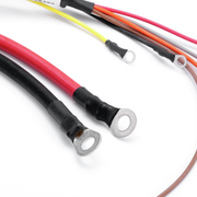 Close-up of several electrical wire leads with ring terminal connectors, including red, black, yellow, orange, pink, gray, and brown wires, shown on a white background.