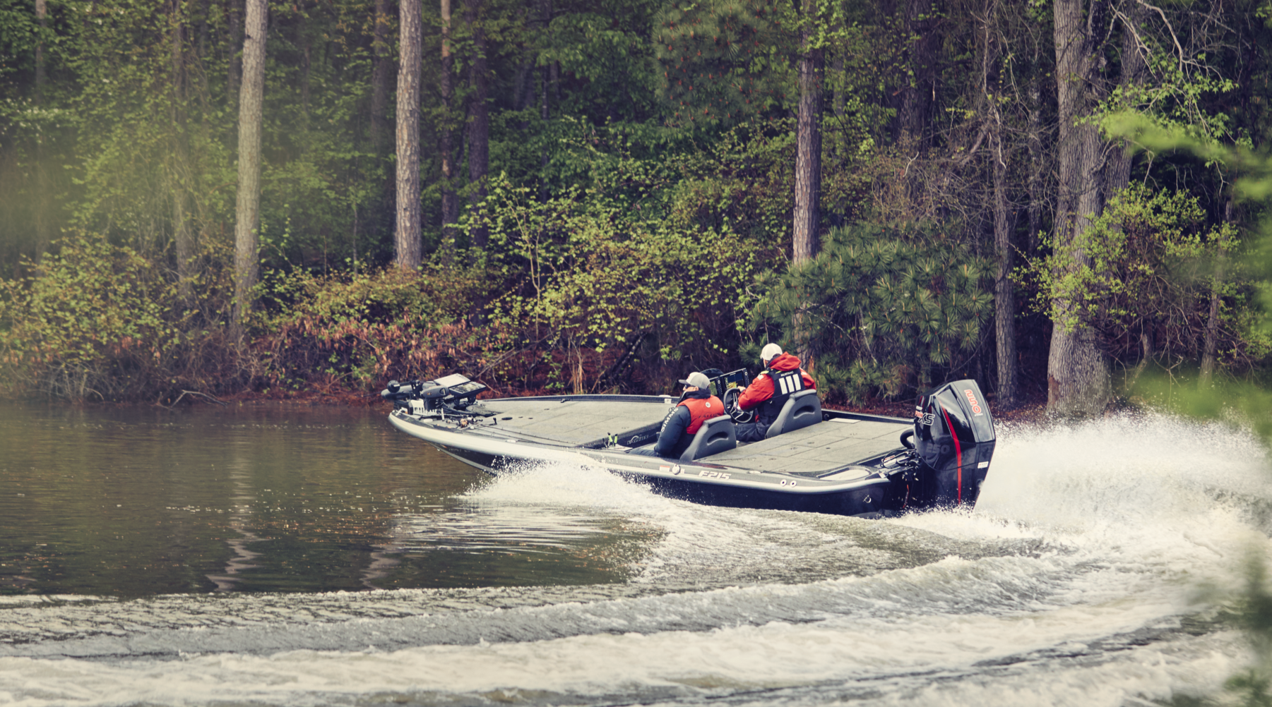 A bass boat with a Mercury outboard engine making a tight turn in fresh water