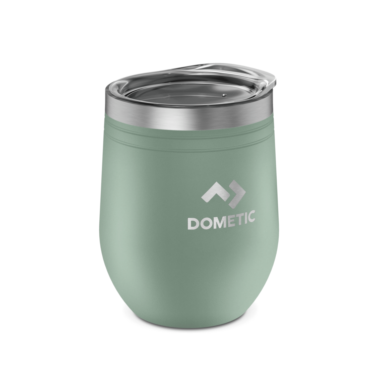 Green insulated tumbler with clear lid on a white background, featuring Dometic logo.