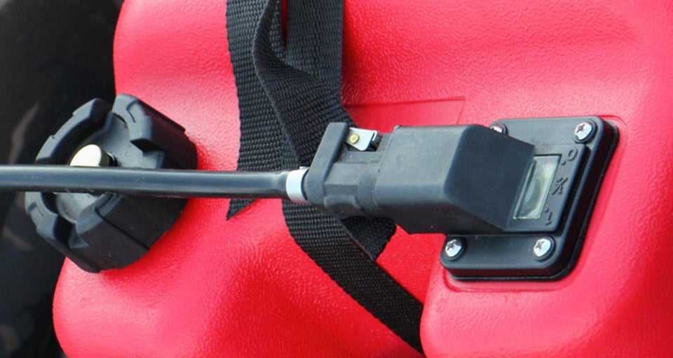 A fuel connector and fuel line hose connected to red marine fuel tank
