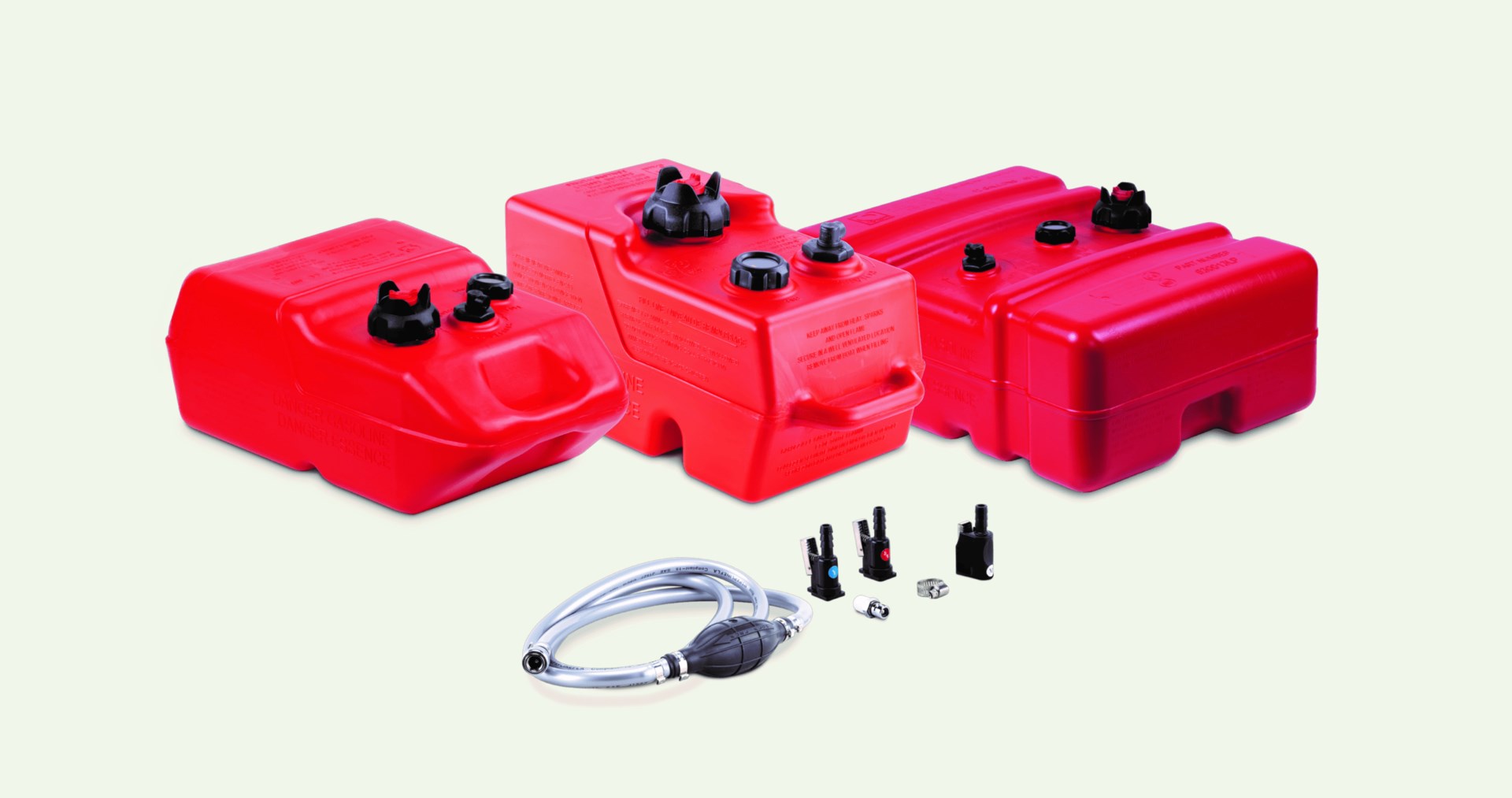 A collection of red Moeller and Sierra portable marine fuel tanks against a solid cream colored background